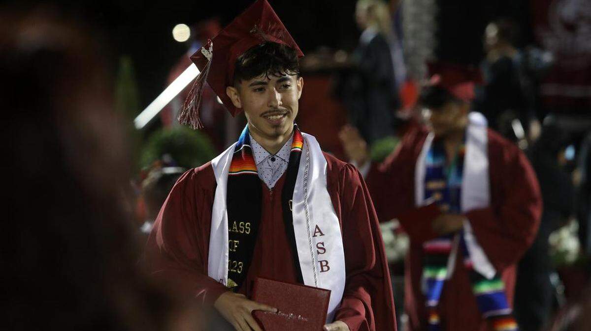 Lionel Pérez-Santiago smiles after getting his diploma during the first graduation ceremony for Matilda Torres High School at Madera Memorial Stadium on June 10, 2023.