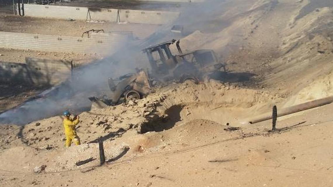 
The smoldering remains of a backhoe sit next to a blast crater where a Pacific Gas & Electric Co. pipeline was ruptured and exploded April 17, 2015, at the Fresno County Sheriff’s Foundation Gun Range near Highway 99 and the San Joaquin River in north Fresno.
