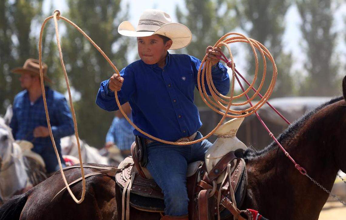 Junior Jiménez, 10, of Madera, performs rope tricks during the 45th annual Joaquín Murrieta Horse Pilgrimage at Three Rocks on July 30, 2023.