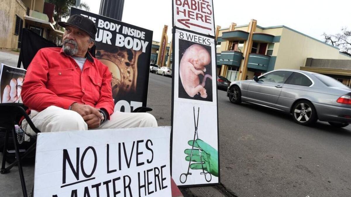 Daniel Perez watches for out for potential Planned Parenthood clients in hopes of dissuading them from using services at the clinic on Fulton Street near downtown Fresno in this 2017 file photo.