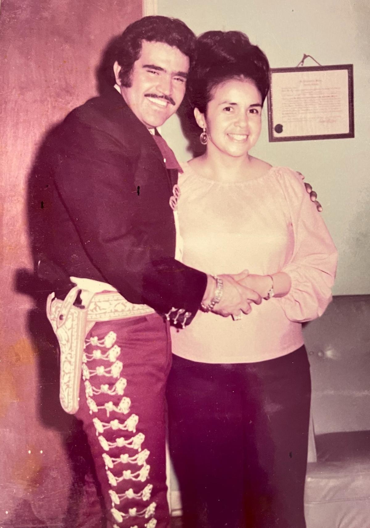 Andrea Gutierrez Lopez, right, met Vicente Fernández at a concert in 1974. Her son, Roberto Lopez, keeps this photo in his wallet.