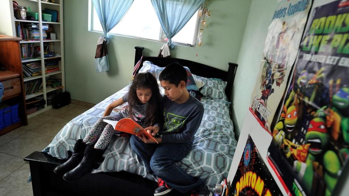 Siblings Diana Carrillo Guzman and Logan Carrillo Guzman read a book in his renovated bedroom of the family home just outside of Fresno in this 2016 file photo. The home was in a shambles when the family bought it for $40,000 in 2012. Mother Maria Guzman is a member of Familias Addams Por Un Mejor Futuro, which sued Fresno for failing to comply with zoning laws to identify land for low-income housing.