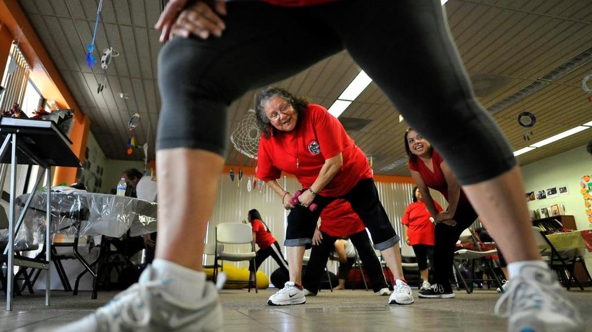 Framed by Eleanor Castro's legs, Andrea Moreno, center, and Eleanor Verdugo work out in an exercise class at the Fresno American Indian Health Project in April 2015, which utilizes a plan to help patients prevent diabetes and for those diagnosed with diabetes to keep it under control.