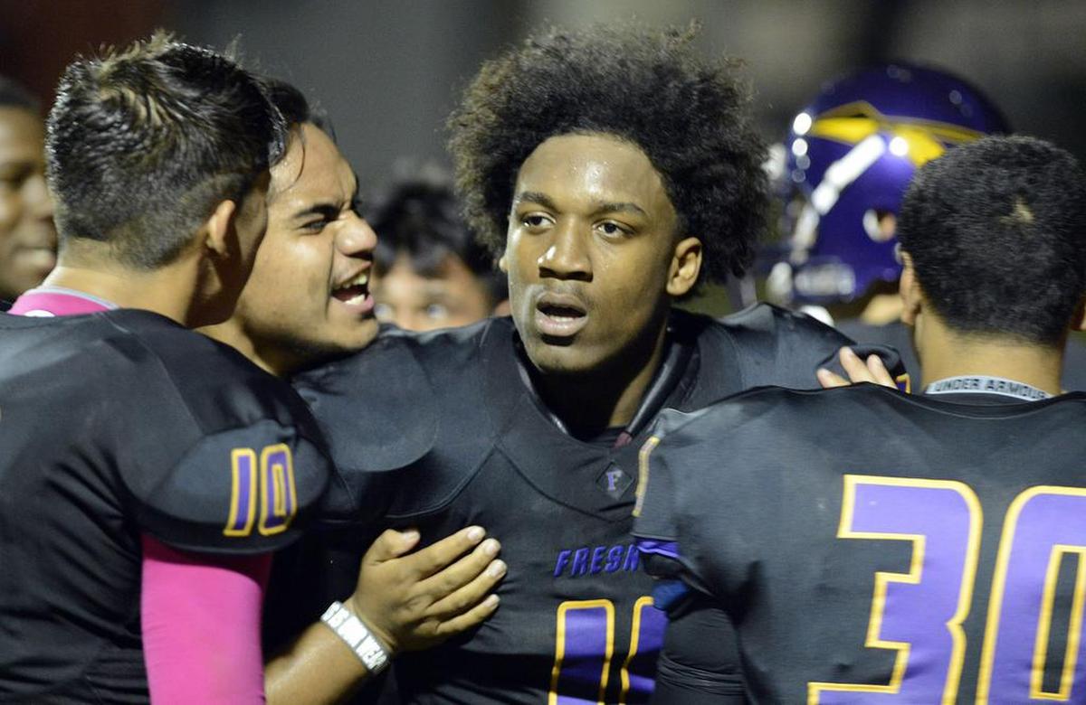 Fresno’s Lee Major, center, celebrates with teammates after breaking up the final pass of the game against Sunnyside at McLane Stadium Friday, Oct. 16, 2015. Major was shot and killed in Fowler on early Sunday, Dec. 15, 2019.