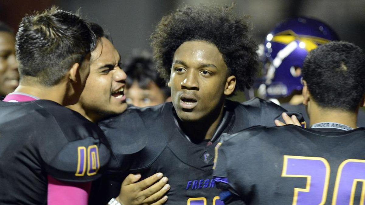 Fresno’s Lee Major, center, celebrates with teammates after breaking up the final pass of the game against Sunnyside at McLane Stadium Friday, Oct. 16, 2015. Major was shot and killed in Fowler on early Sunday, Dec. 15, 2019.