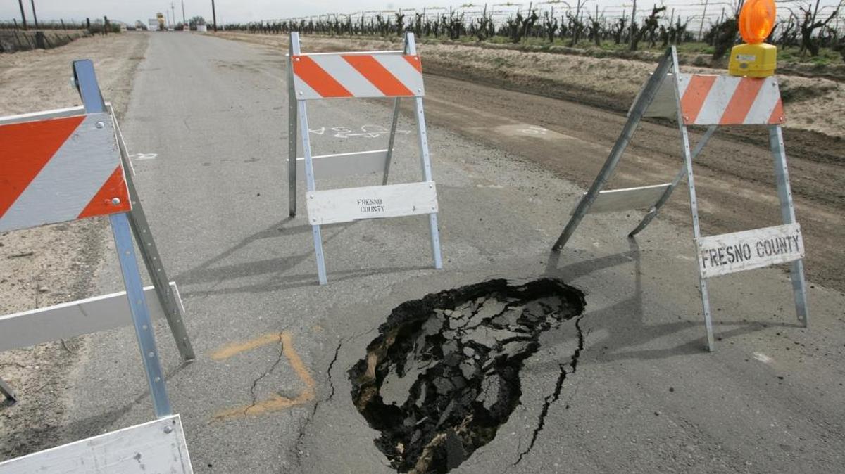 A section of Sierra Avenue near Jameson Avenue in Fresno County was closed for potholes and underlying structural problems because of heavy rains in this 2012 file photo. Potholes are among constituent concerns that Fresno County supervisors are seeking the flexibility to address in their individual district budgets.