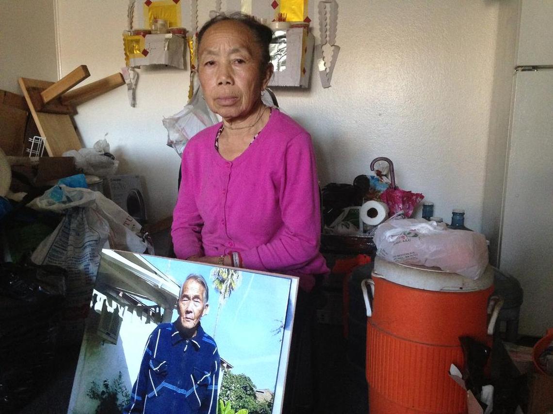 Tong Cha holds a photo of her husband, Her Xa Lor, who died in January 2016 of complications from respiratory failure and pneumonia after falling ill when heat was turned off at Summerset Village Apartments in Fresno in November 2015.