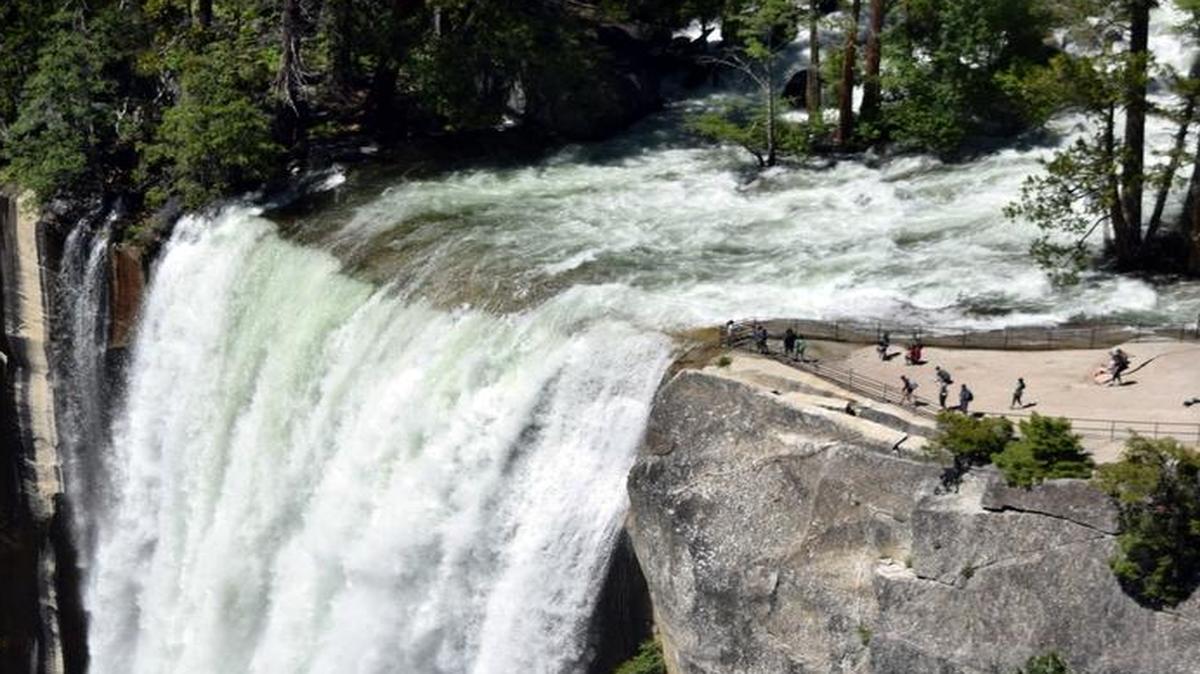 Yosemite’s Vernal Falls is a torrent of water, with onlookers dwarfed by the spectacle, upper right, as they look on from the observation deck Tuesday afternoon.