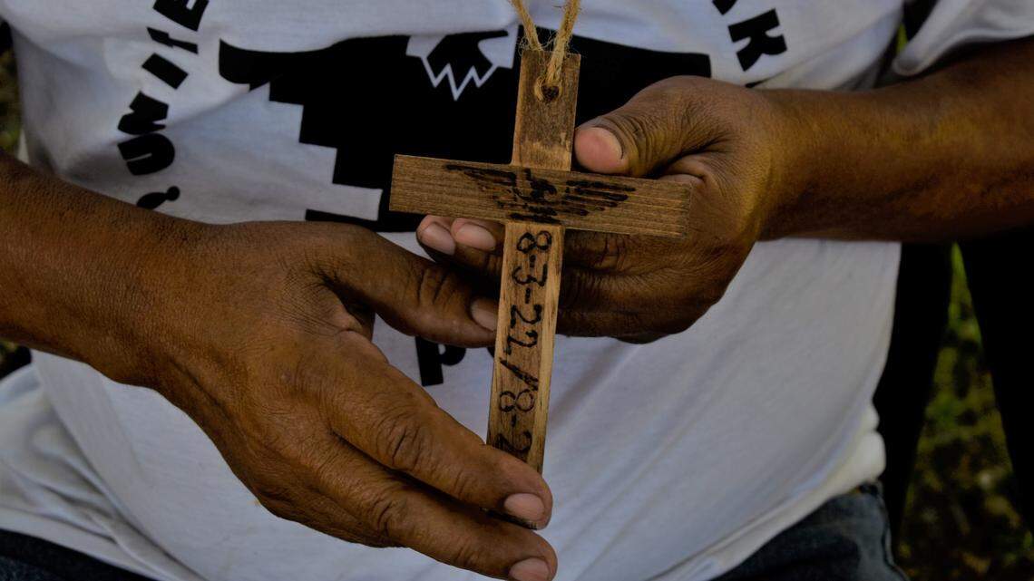 Angel Noriega, a United Farm Workers supporter, was given a blessed wooden cross for participating in both the union’s 1994 and 2022 marches. He is participating in a vigil outside the state government offices in Fresno to pressure Gov. Gavin Newsom to sign a bill that would grant farmworkers the flexibility to vote by mail in union elections.