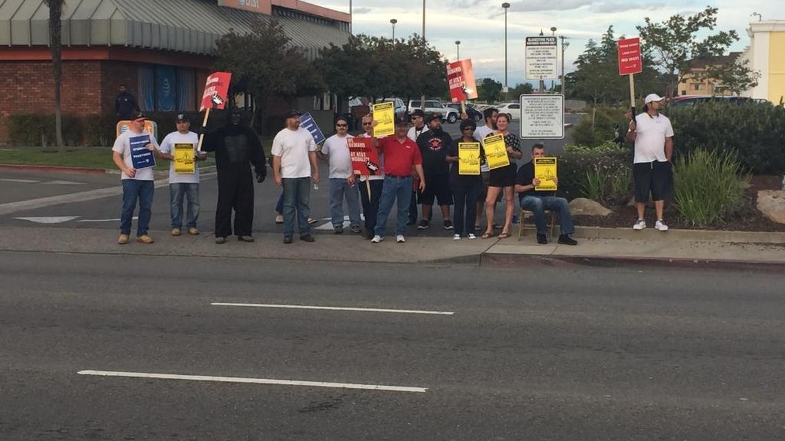 AT&T employees protested outside a Blackstone Avenue store Wednesday after the company has delayed to bargain with the union over their workers contacts.