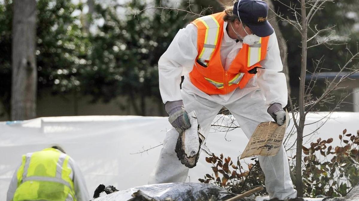 City of Fresno code enforcement supervisor Howard Lacy, right, sifts through the rubble of the Rehorn Home looking for historical items to salvage Thursday afternoon, Feb. 4, in Fresno.