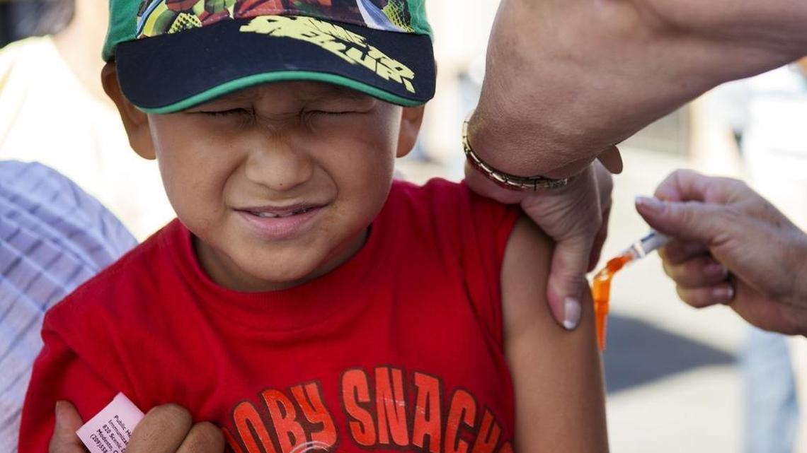 This youngster winced as he got a shot in Modesto in 2014.