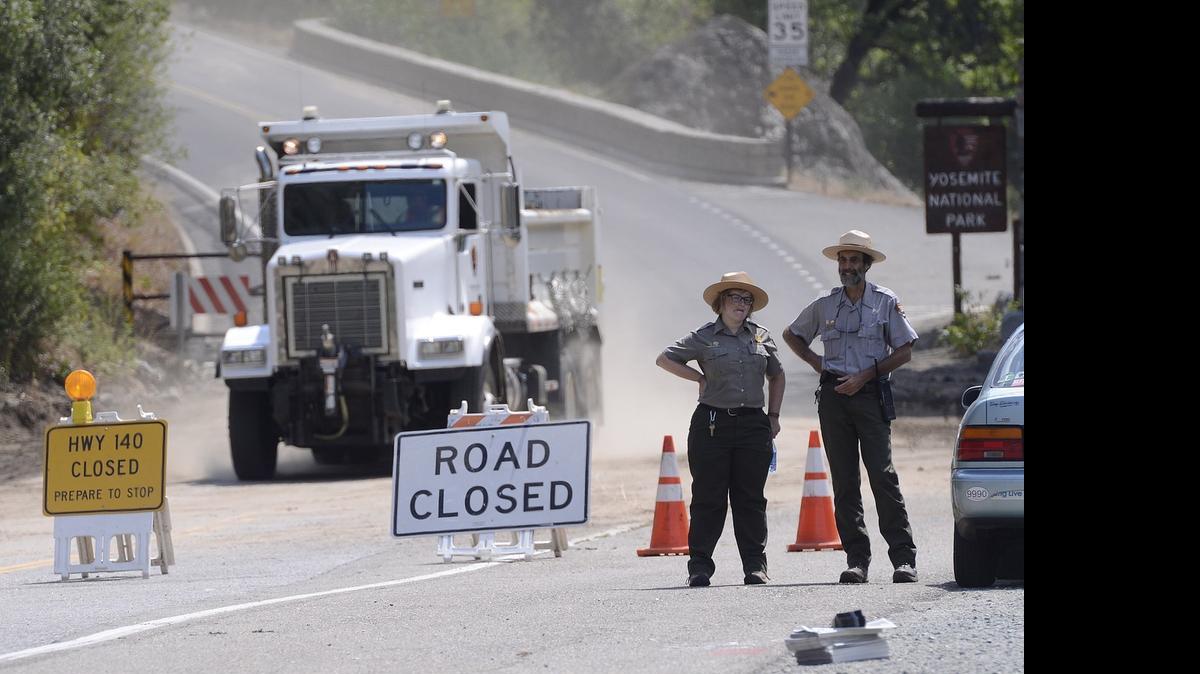 
National Park Service rangers Lesley Palfreyman and Glenn Gibbons stood watch at the closed section of Highway 140 Wednesday.
