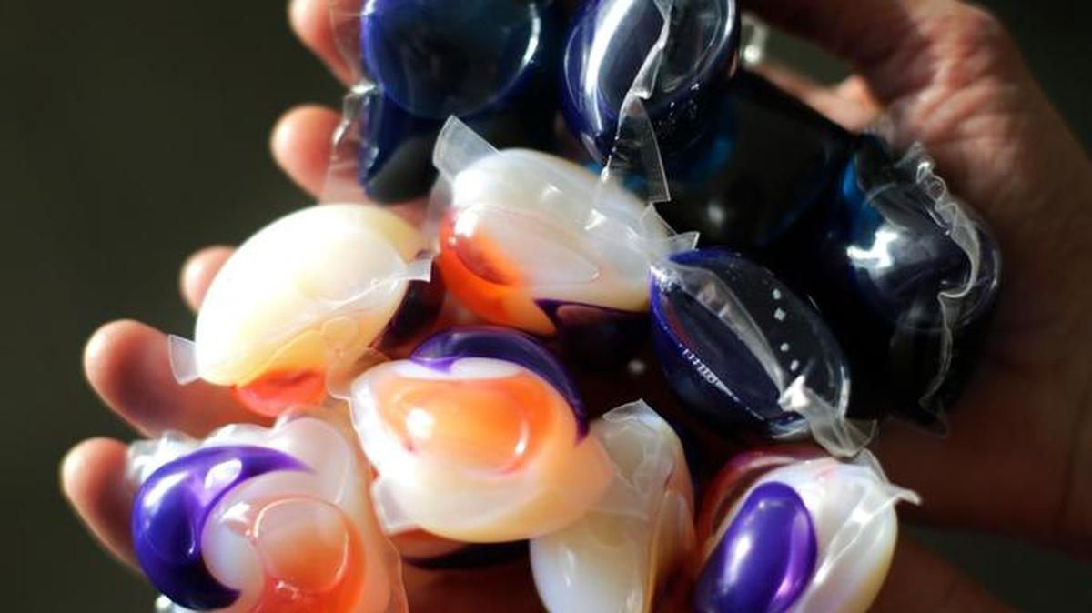 In this photo taken Friday, Nov. 7, 2014, laundry detergent packets are held for a photo. Consumer Reports said on June 15, 2017, that accidental poisonings from liquid laundry detergent packets pose a risk for adults with dementia as well as for children.