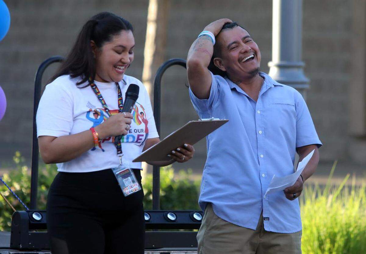 Valeria Rodríguez interprets for Alex Jiménez at the Fresno Economic Opportunities Commission ‘Illuminate Our Pride and Our Mental Health’ street festival on Fulton Street on June 24, 2023. The celebration was organized by the EOC LGBTQ+ Resource Center.