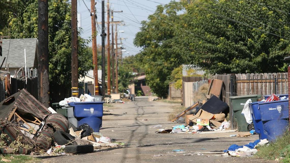 
Trash spills over into an alley north of McKenzie Street in the city's poverty-stricken central core. The city of Fresno unveiled a new smartphone app that would allow city residents to report city code violations, potholes, trash and other problems. 
