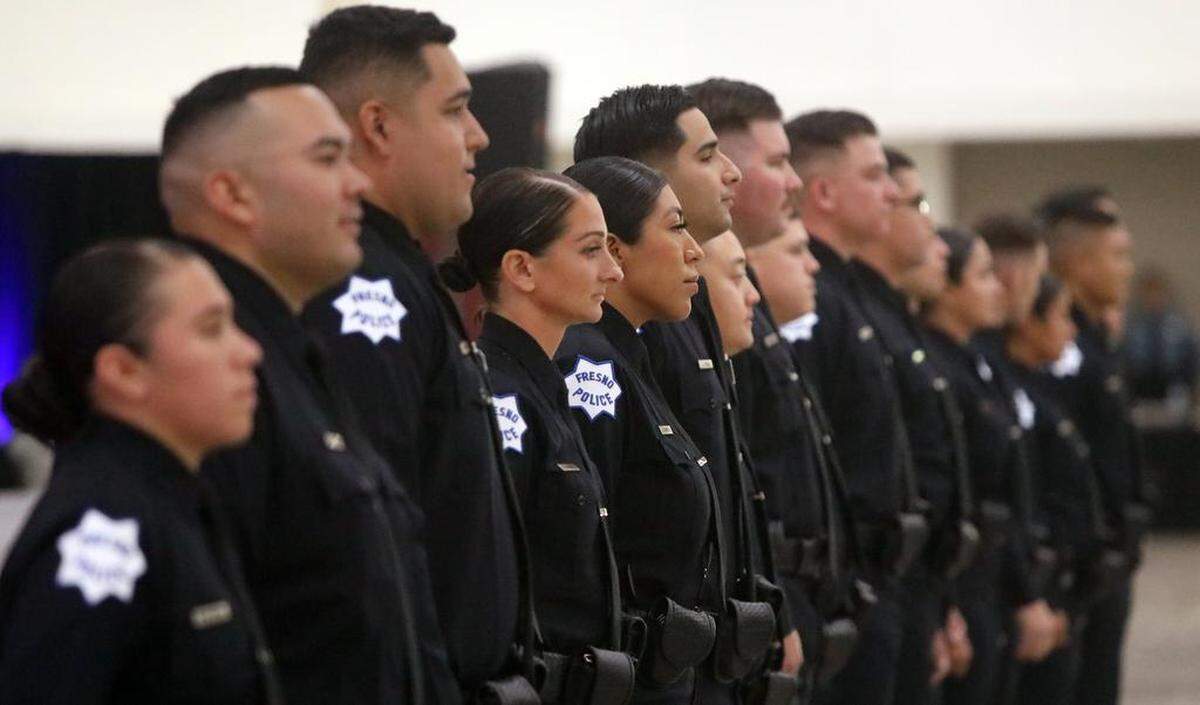 New Fresno Police Officers Angela Gibbons and Jazmín García are flanked by other new officer during the Sept. 1, 2023 swearing-in ceremony at the Fresno Convention Center.