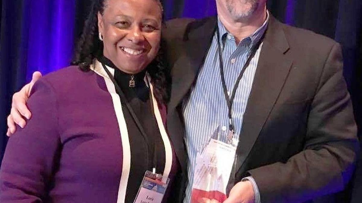 Andy Souza, right, CEO of Fresno’s Community Food Bank, holds the Dick Goebel Award for public service to end hunger, presented Monday in Washington, D.C. Joining him is another Fresnan, Lorie Brewer of the Building Better Communities Foundation.