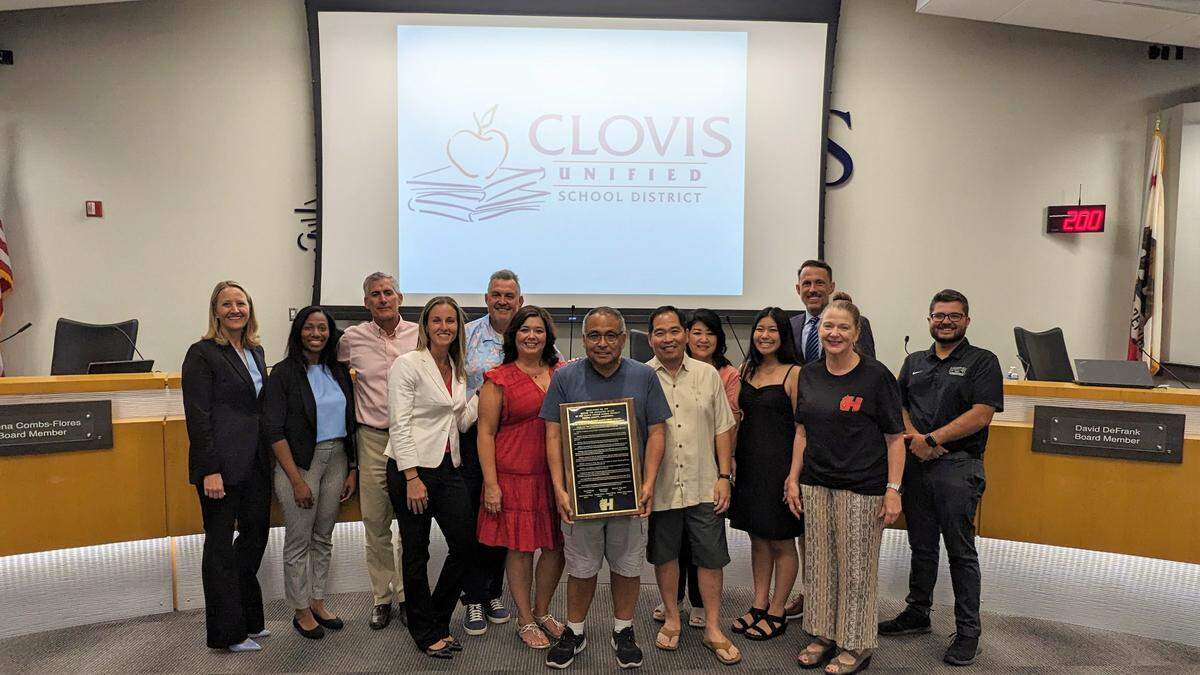 The Clovis Unified School District board granted the Hirayama family - including Kevin Hirayama (center with plaque) and Brian Hirayama (right, next to Kevin) - a proclamation plaque in honor of Satoshi “Fibber” Hirayama, a professional baseball player and beloved local educator, during a board meeting on July 12, 2023. Hirayama Elementary is the first school in Clovis named after a Japanese-American person and will open in August 2024.