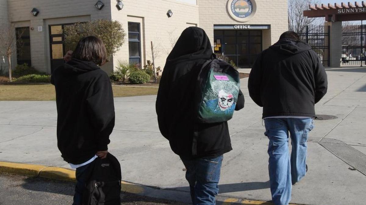 Two truant juveniles are led back to Sunnyside High School by a campus safety assistant in 2008.