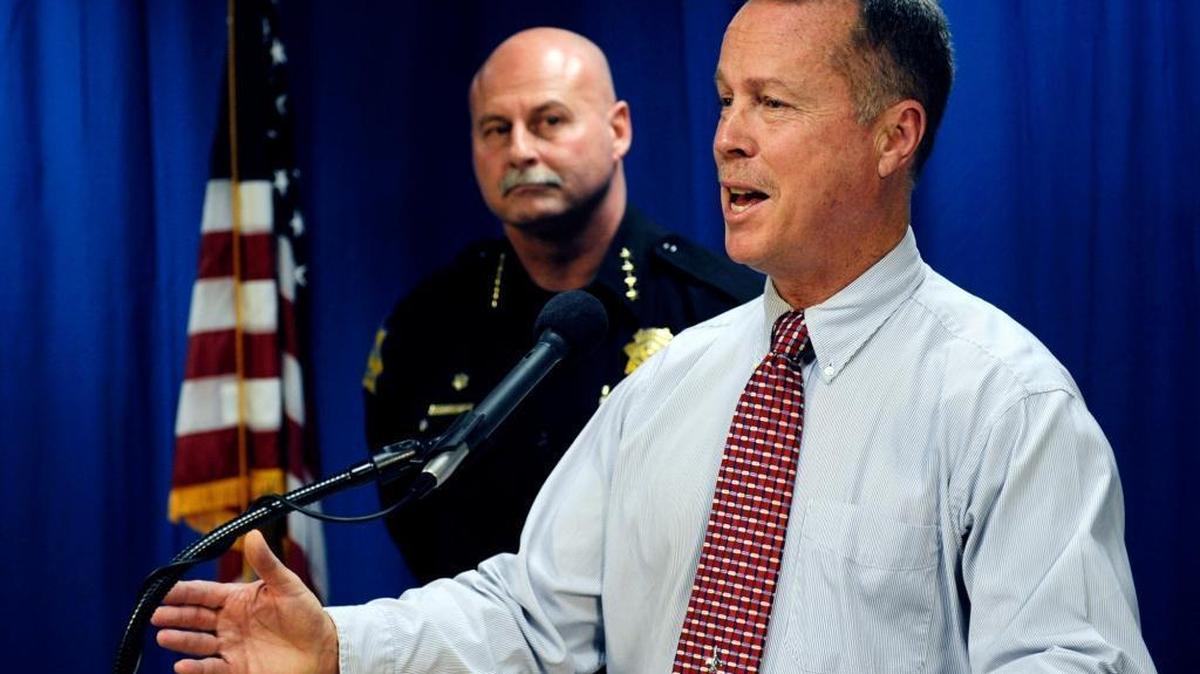 Fresno police Chief Jerry Dyer, left, listens as Rick Rasmussen, director of the city’s Office of Independent Review, announces the release of his first quarterly report on the Fresno Police Department in early 2013. On Monday, Rasmussen said the department needed to complete officer-involved shooting investigations quicker.
