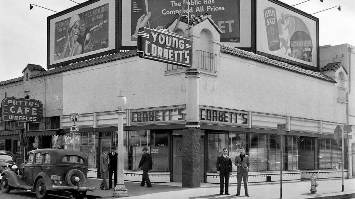 THEN: Fresno boxing legend Young Corbett III (Ralph Giordano), in dark suit at center left, stands in front of his Young Corbett’s lounge in 1939 at Mariposa and Broadway streets.