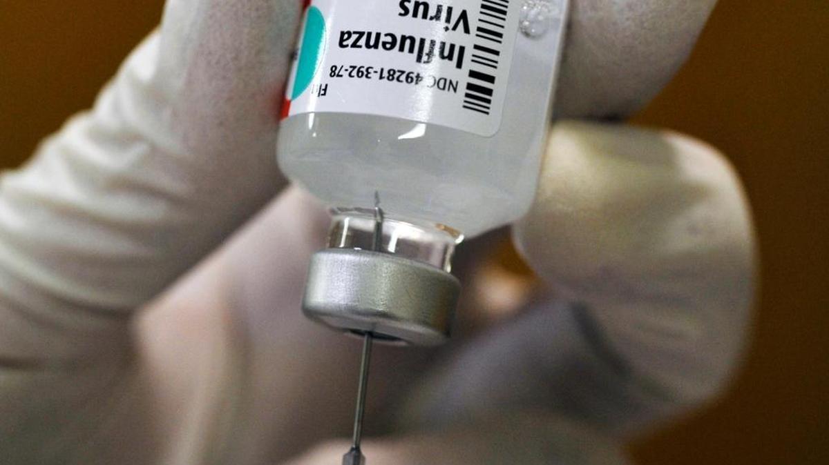 In a 2014 file photo, an injection of the influenza virus vaccine is prepared at a Fresno County Department of Health immunization clinic on Fulton Mall.