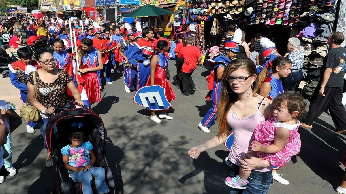 Fairgoers pack part of the midway at the Big Fresno Fair.