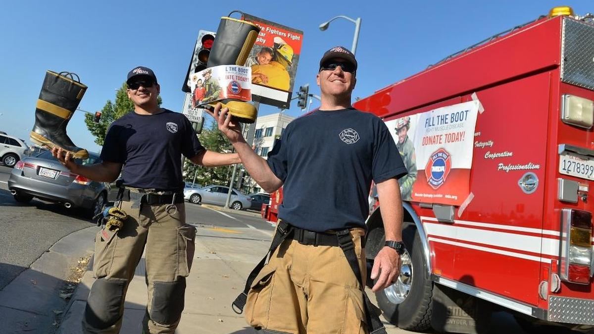 Fresno County Fire/Cal Fire engineer Erik Rodriguez, left, and fire Capt. Jason Luckenbach collect donations for the ‘Fill the Boot’ campaign to benefit the Muscular Dystrophy Association in May 2016. Fresno and Clovis firefighters will collect donations on Thursday, Oct. 20, for Muscular Dystrophy Association.
