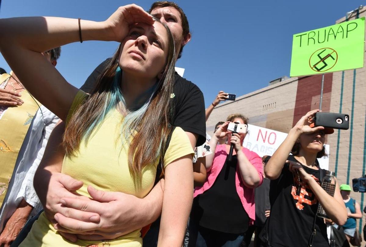 Beth Tritch and Cameron Remine, listen to a speaker during the “Fresno’s Counter Rally Against Hate,” in the Tower District Saturday morning, Aug. 26, 2017.