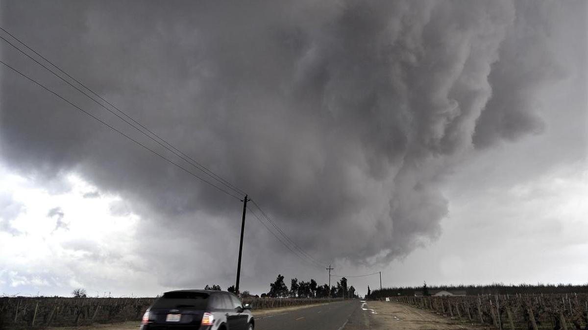 Angry storm clouds roll over Howard Avenue south of Biola in Fresno County, Tuesday afternoon, Jan. 5. State officials worry that recent storms will cause backsliding on water conservation goals.