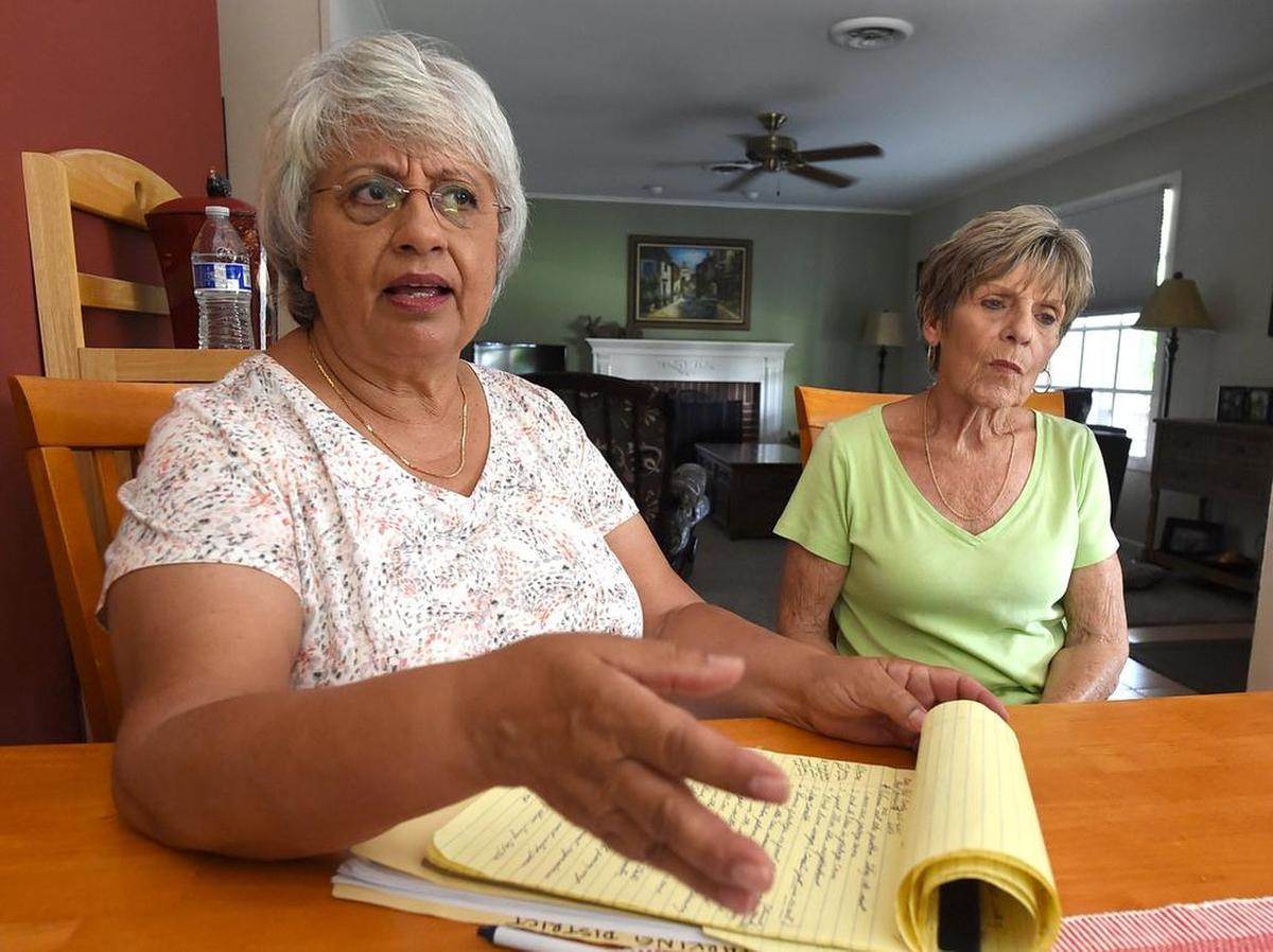 Helen Moordigian, left, with neighbor Suzette Peterson, voice frustration with the parking situation in the neighborhood north of the VA Hospital, July 25, 2018. 