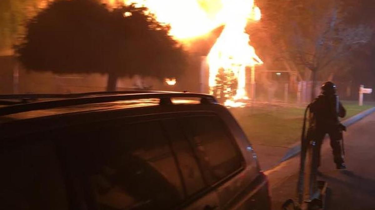 Fire crews attack a southeast Fresno home that was fully engulfed in flames early Sunday morning, Dec. 27, 2015.