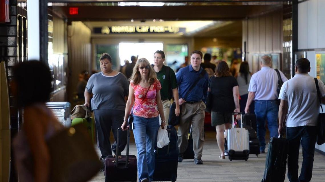 In a June 2013 file photo, people return from retrieving their bags from the baggage claim area at Fresno Yosemite International Airport.