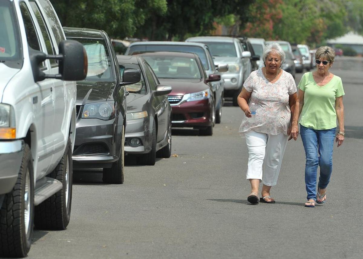 A shared daily frustration for Helen Moordigian, center, and Suzette Peterson, who live in the neighborhood north of the VA Hospital, one that they say has gone on for decades- is the nearly endless lines of bumper-to-bumper cars of employees of the hospital.