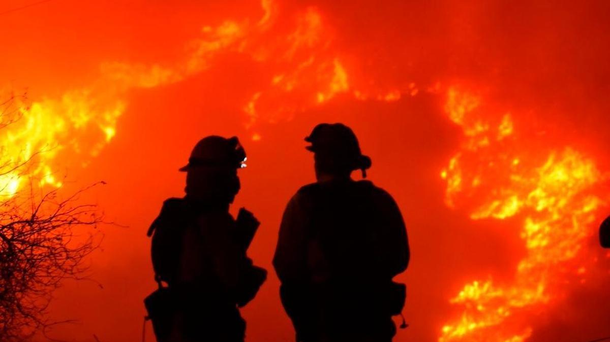 Firefighters keep a close eye on flames threatening homes in the Santa Barbara County community of Carpinteria in this Dec. 10 photo. Disneyland is sending free one-day park tickets to fire departments across the state, including the city of Fresno, to thank them for their help in last year’s hectic wildfire season.