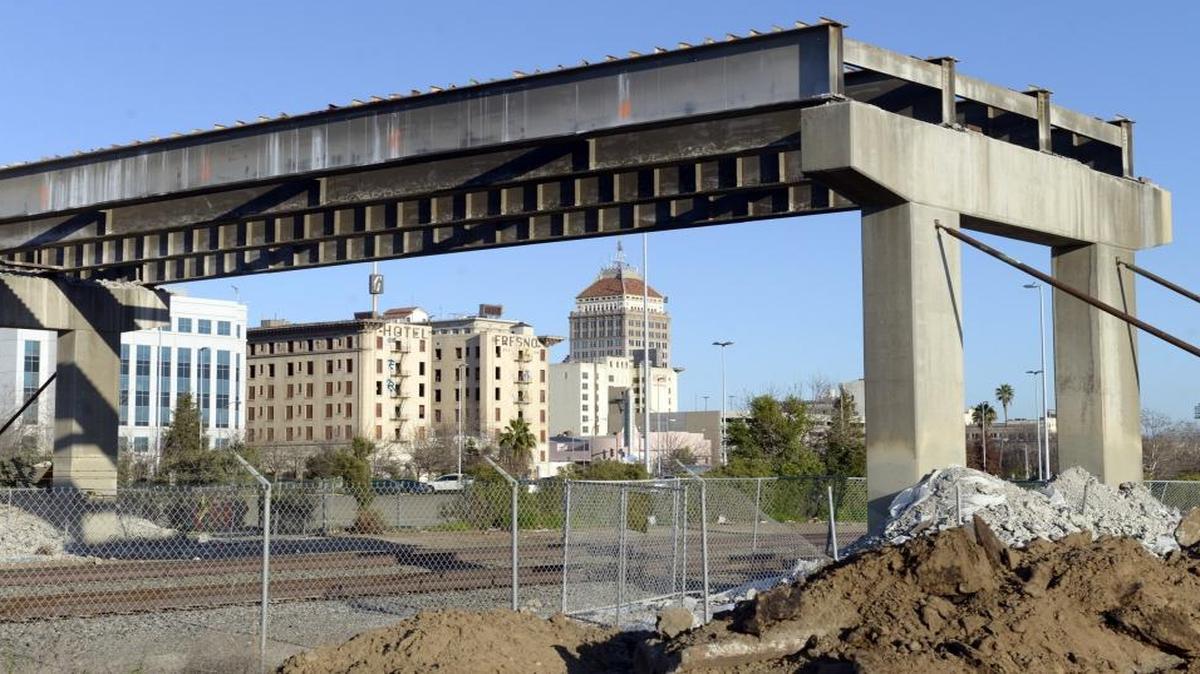 The half-demolished Tulolumne Street bridge appears in front of the downtown Fresno skyline under clear skies Thursday afternoon after morning showers blew through the region. Clear skies and sun will continue for at least the next week.