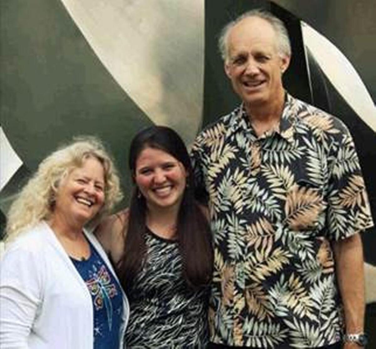 In this undated photograph, Kira Sandiford, center, stands with her parents, Elise and Robert Sandiford. The couple were killed in a May 25, 2016, crash on Highway 99 near Avenue 16 in Madera County.