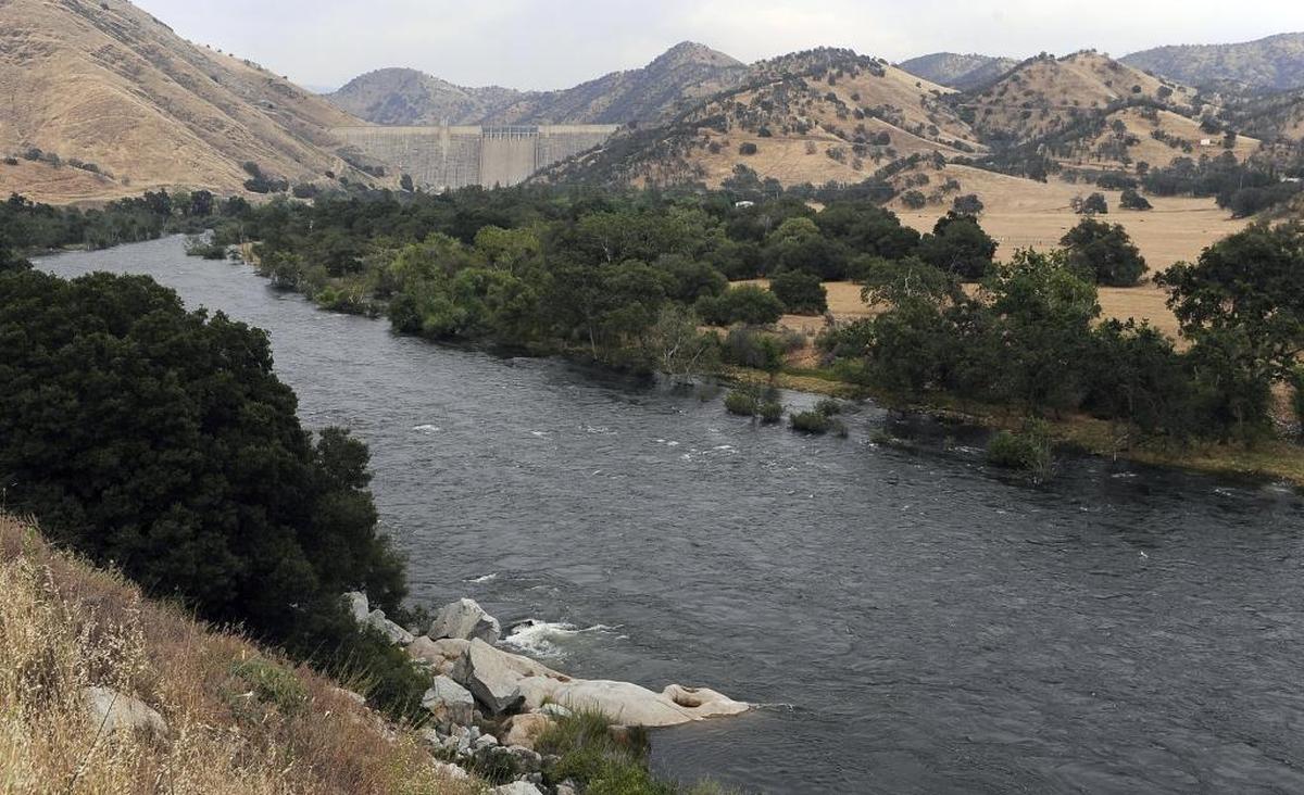 The swollen Kings River flows downstream of Pine Flat Dam, background, Wednesday afternoon, May 24, 2017 near Piedra, Calif. Fresno County has closed portions of the Kings River due to dangerous flows.
