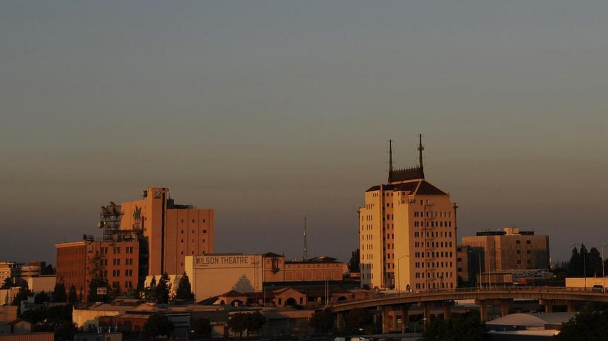 A layer of bad air hugs the skyline of downtown Fresno in July 2013. A report by the American Lung Association gave Valley counties a failing grade for air quality. Local officials say the report uses old data and that air quality has improved recently.