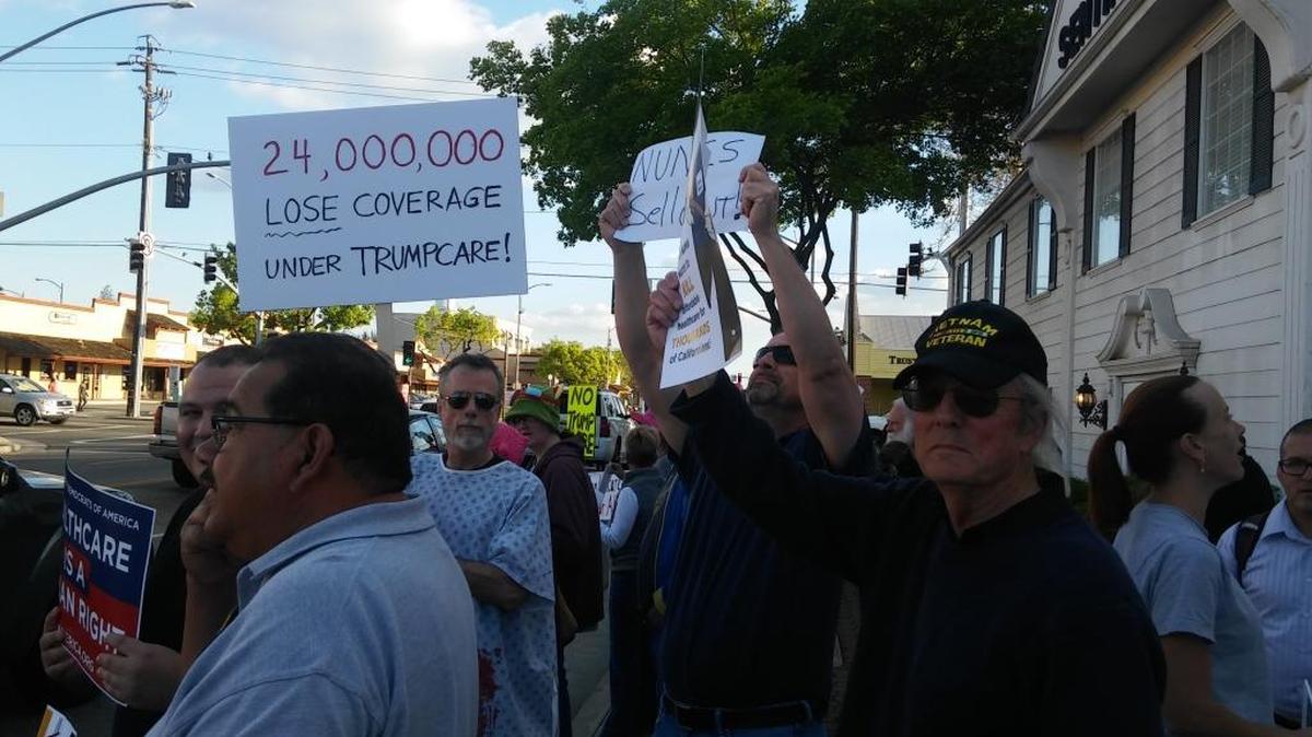 Protesters stand outside the office of Rep. Devin Nunes on Thursday, March 23, 2017, to ask him to vote against repealing the Affordable Care Act.