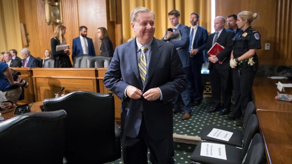 Sen. Lindsay Graham, R-S.C., returns to the Senate Finance Committee room to testify after the hearing on his last-ditch GOP push to overhaul the nation's health care system was paused when activists disrupted the hearing on Capitol Hill in Washington, Monday, Sept. 25, 2017.