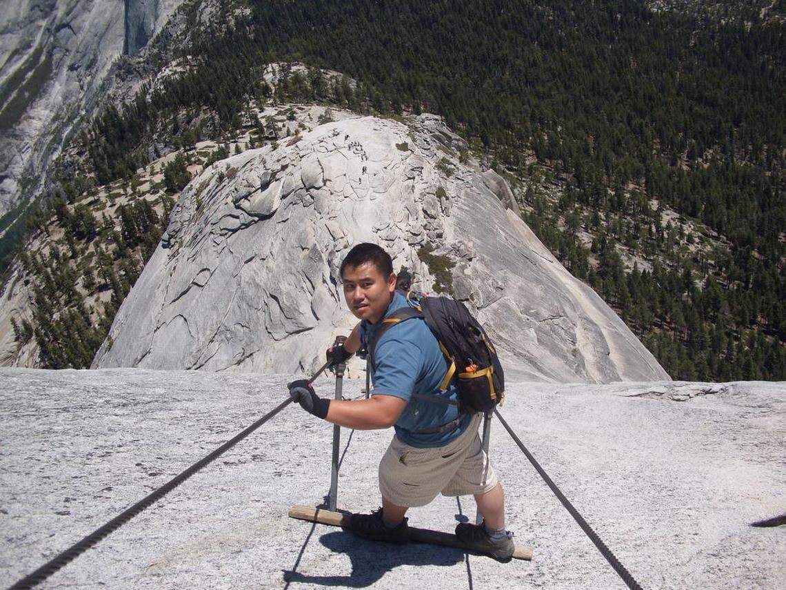 A hiker stops to pose for a photo before making his way down the infamous cables section on Half Dome in Yosemite National Park.