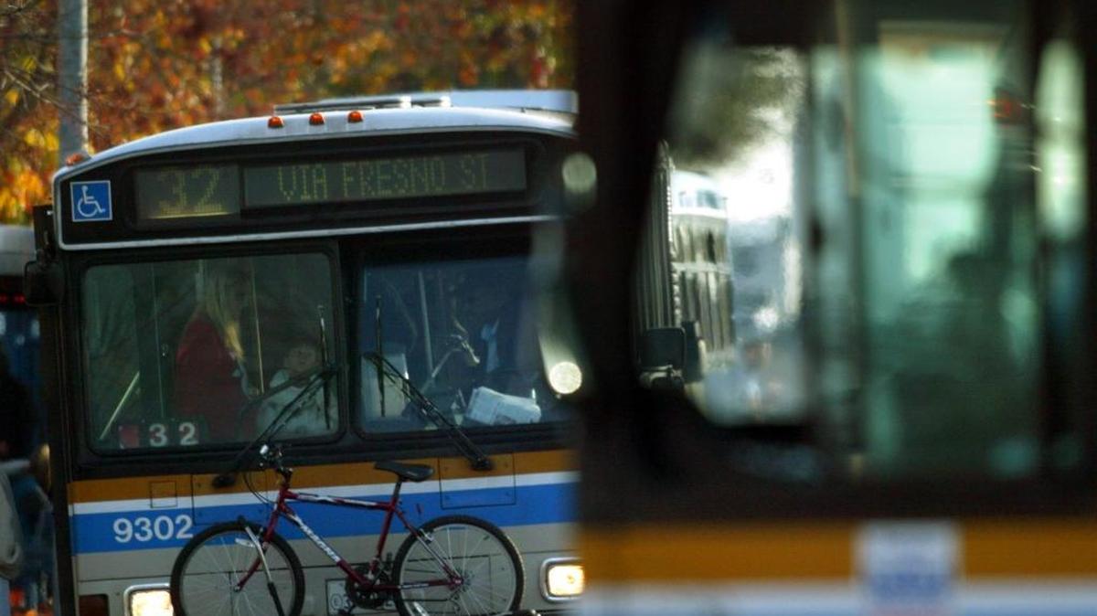 Passengers board a Fresno Area Express bus, left, at a Manchester Center bus stop in this file photo.