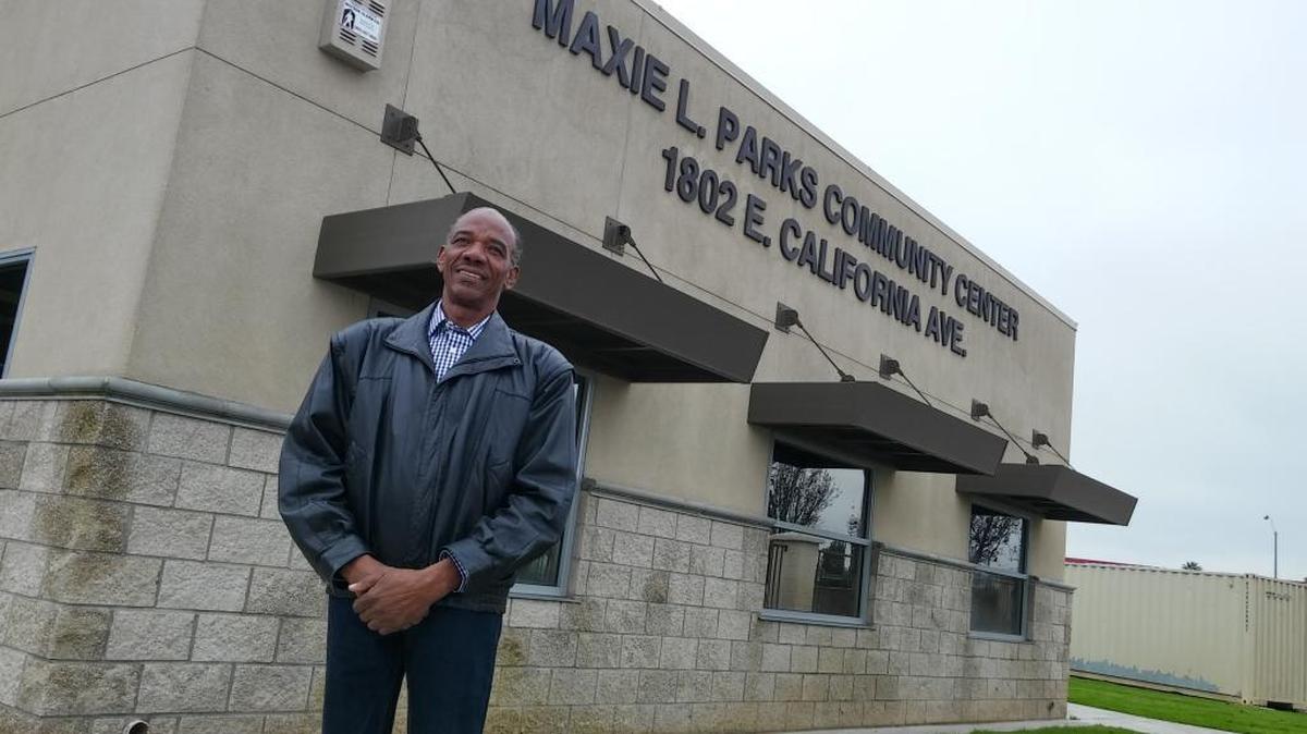 Maxie L. Parks, 65, stands in front of a youth community center renamed after him in southwest Fresno on Saturday.