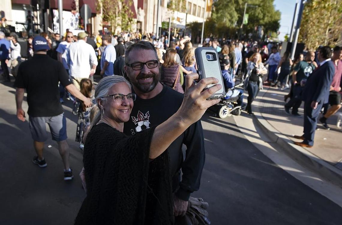 Nina and Jeff Kenny pose for a photo as pedestrians check out newly reopened Fulton Street on Saturday, Oct. 21, 2017.