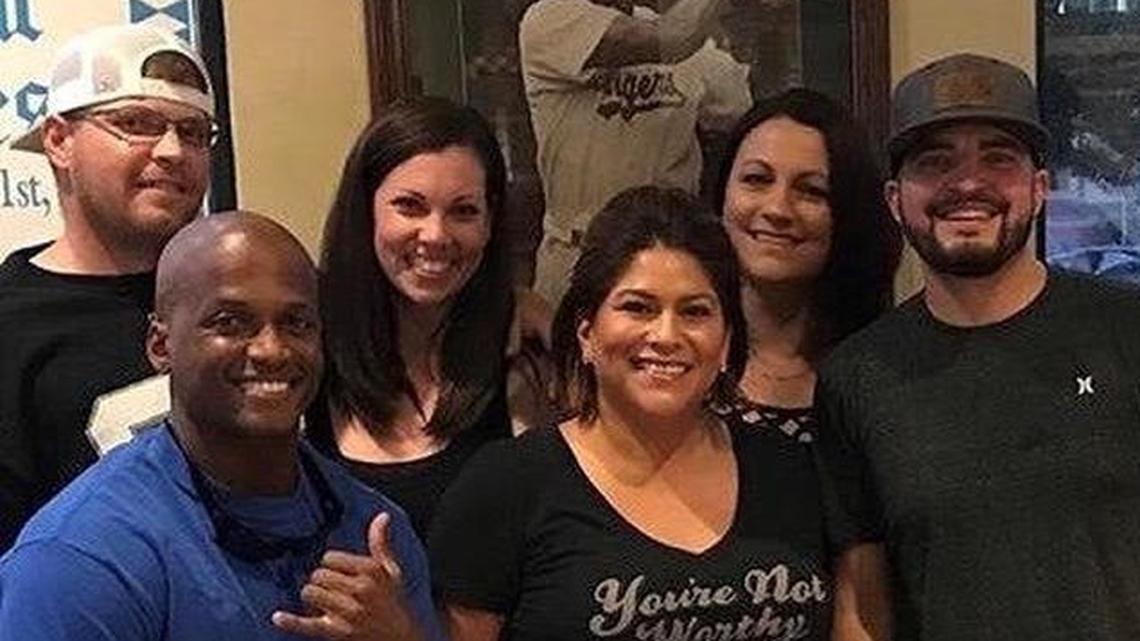 Blake Smith, 36, shown wearing a black shirt and hat, and Brandon Sims, 36, at upper left, are seen with a group of high school friends in 2017.