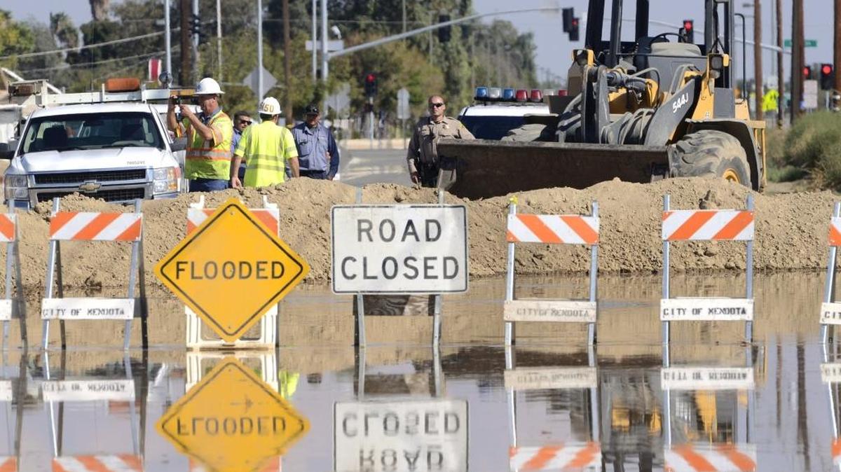 
Floodwater from Thursday night’s storm, runoff from Panoche Creek, reaches the outskirts of Mendota on Friday. The earthen dam was put up to divert the water.
