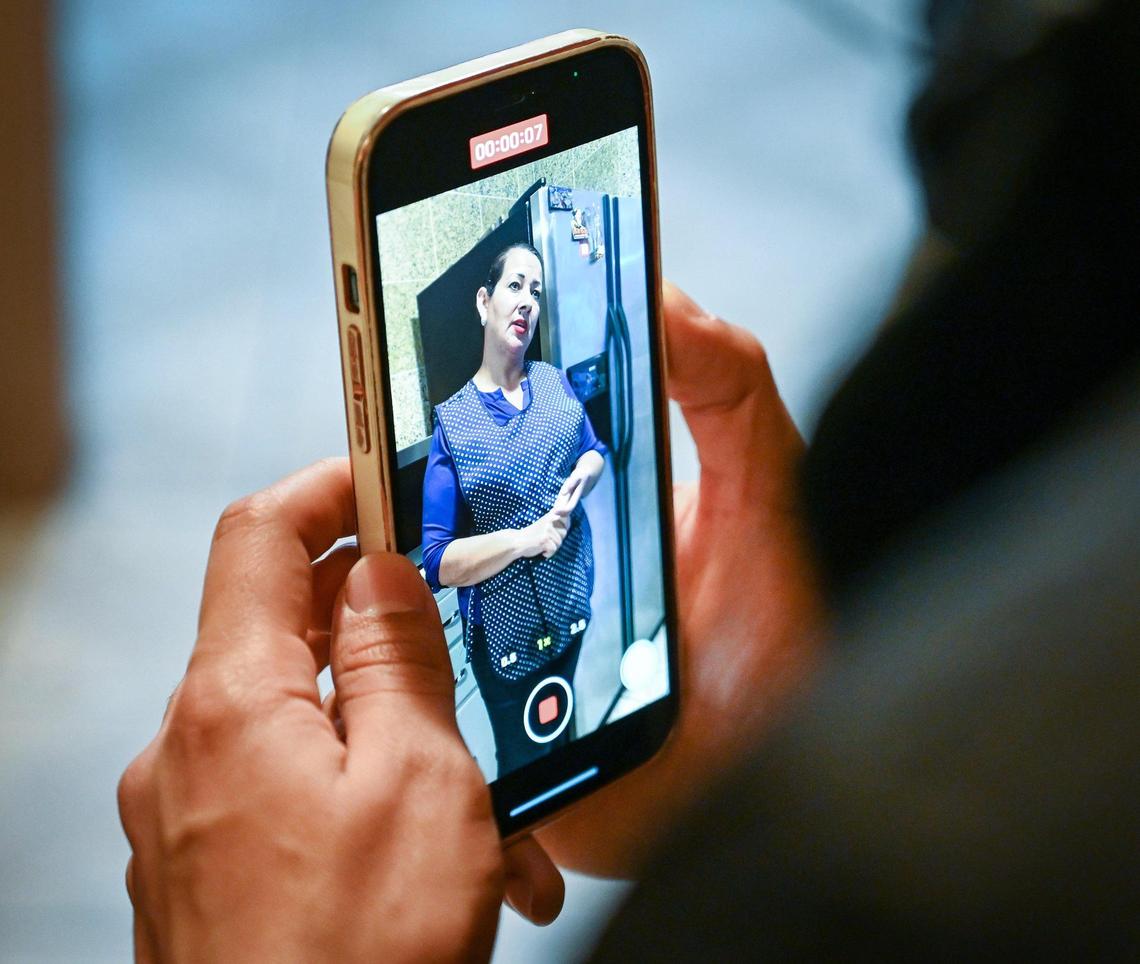 Ruben Vasquez shoots video of his mother, Cristina Leon, while she makes tamales in Ruben’s kitchen in Fresno on Friday, Dec. 17, 2021. Ruben Vasquez has been making TikTok videos of his mother’s cooking, generating a following of more than 55,000.