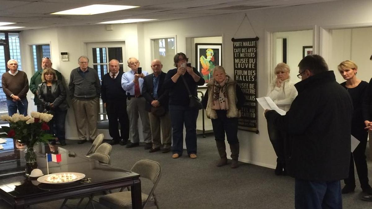 Frédéric Martin leads a gathering at the nonprofit Alliance Française de Fresno in a minute of silence for the victims of the terrorist attacks in Paris